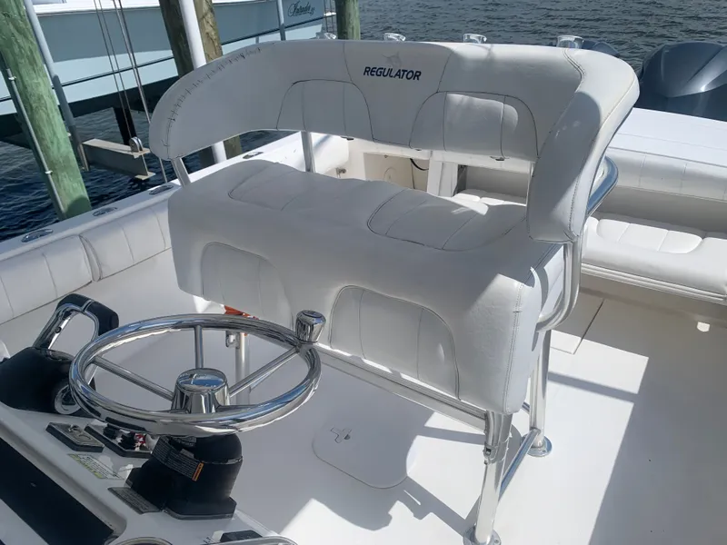 Slide: The Image of Regulator FS 2015 boat helm with white seating and steering wheel. - 3