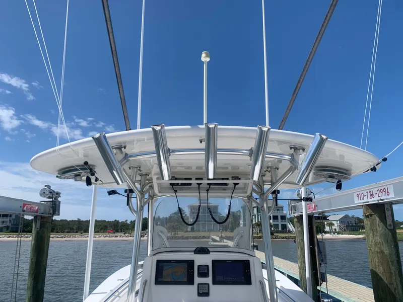 Slide: The Image of 2015 Regulator FS boat with helm console and fishing rod holders. - 49
