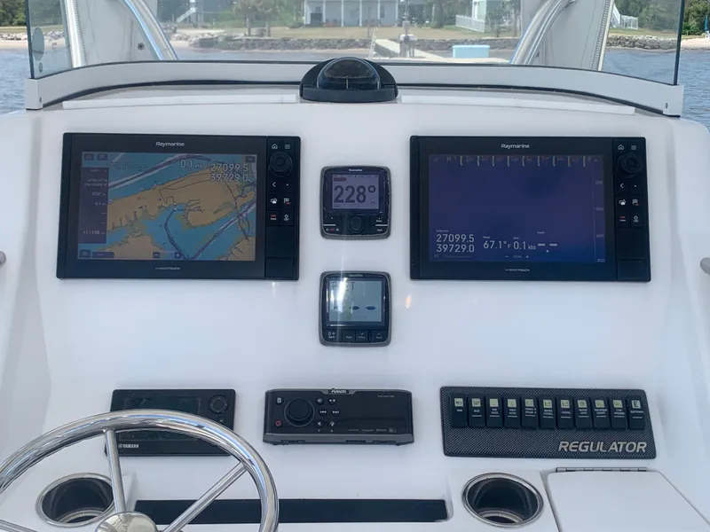 Slide: The Image of 2015 Regulator FS boat helm with navigation systems and controls. - 7