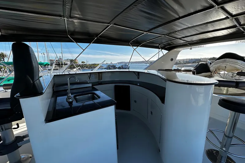 Slide: The Image of Luxurious Monte Fino 92 yacht interior with sleek bar and seating, 1996 model. - 12
