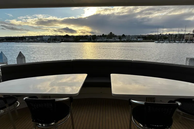 Slide: The Image of Luxury yacht Monte Fino 92, 1996 model, with scenic waterfront view at sunset. - 13