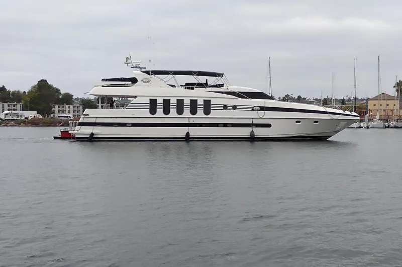 Slide: The Image of Luxurious 1996 Monte Fino 92 yacht docked in a serene marina setting. - 2