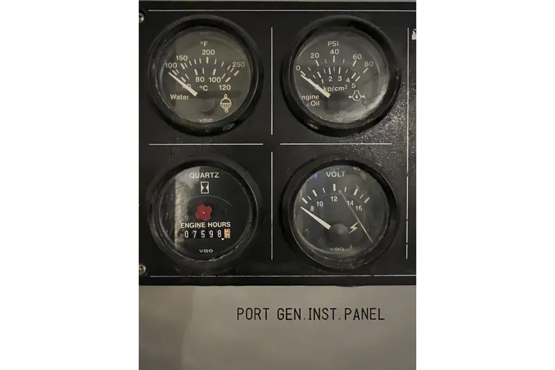 Slide: The Image of Instrument panel of a 1996 Monte Fino 92 yacht showing gauges for water, oil, engine hours, and voltage. - 21