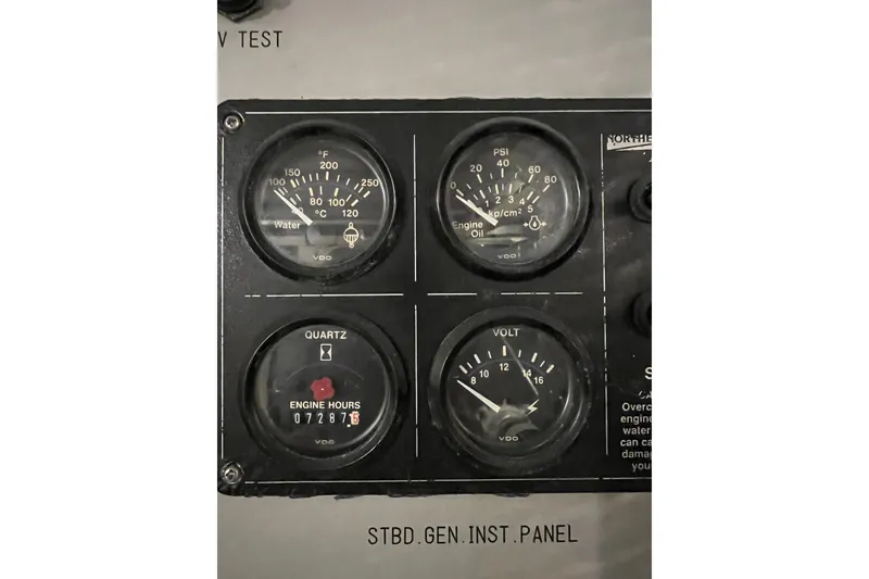 Slide: The Image of Instrument panel of a 1996 Monte Fino 92 yacht showing gauges for water, oil, engine hours, and voltage. - 23
