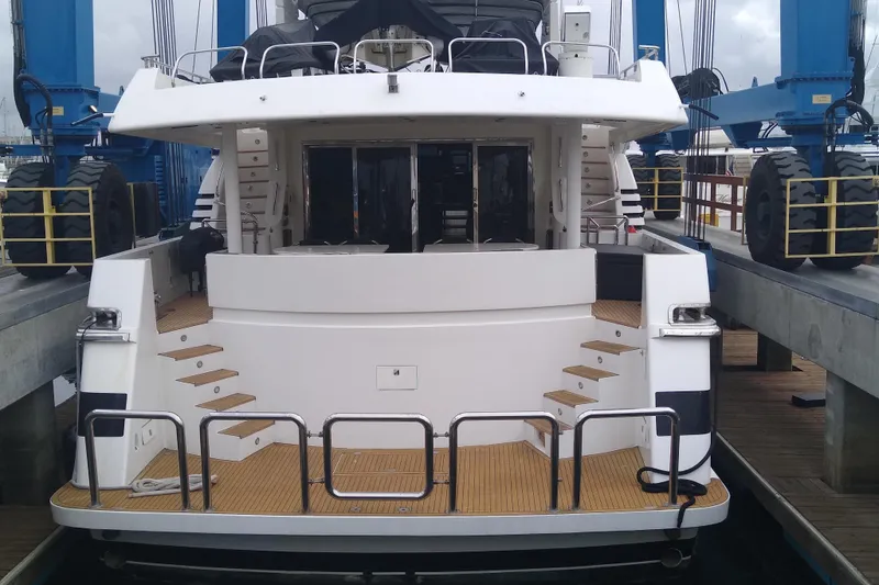 Slide: The Image of Monte Fino 92 yacht from 1996 in dry dock, rear view with wooden deck. - 4