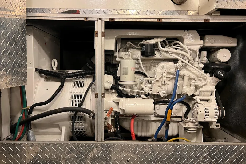 Slide: The Image of Engine compartment of a 1996 Monte Fino 92 yacht, showcasing mechanical components and wiring. - 43