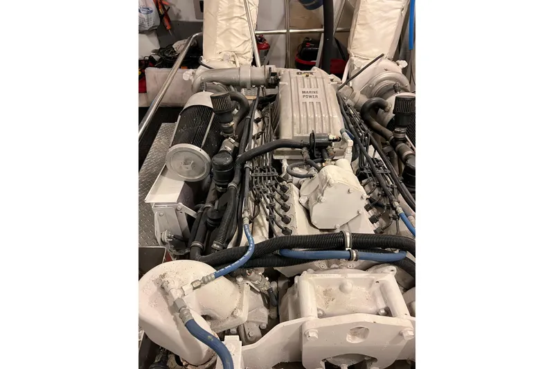 Slide: The Image of Engine room of a 1996 Monte Fino 92 yacht, showcasing marine power components. - 49