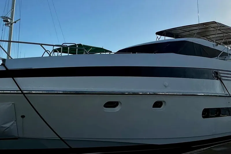 Slide: The Image of Monte Fino 92 yacht from 1996, docked with a clear blue sky backdrop. - 5