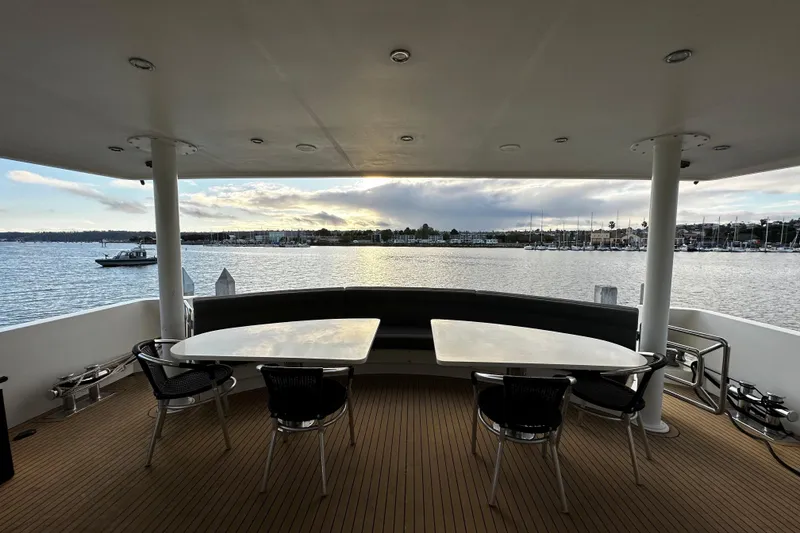 Slide: The Image of Deck view from 1996 Monte Fino 92 yacht, overlooking serene marina at sunset. - 51