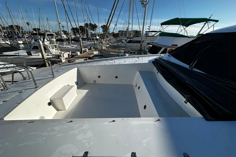 Slide: The Image of Monte Fino 92 yacht deck, 1996 model, docked in a marina with sailboats. - 52