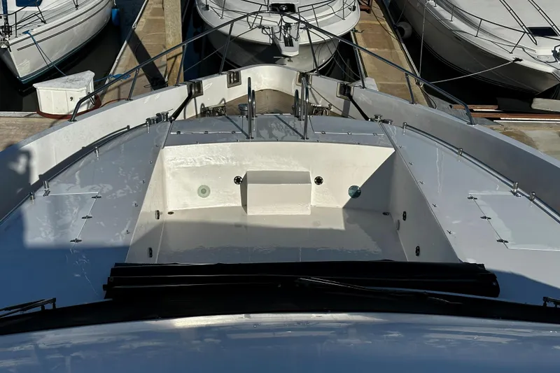 Slide: The Image of Monte Fino 92 yacht bow view, docked, showcasing sleek design and spacious deck. - 54