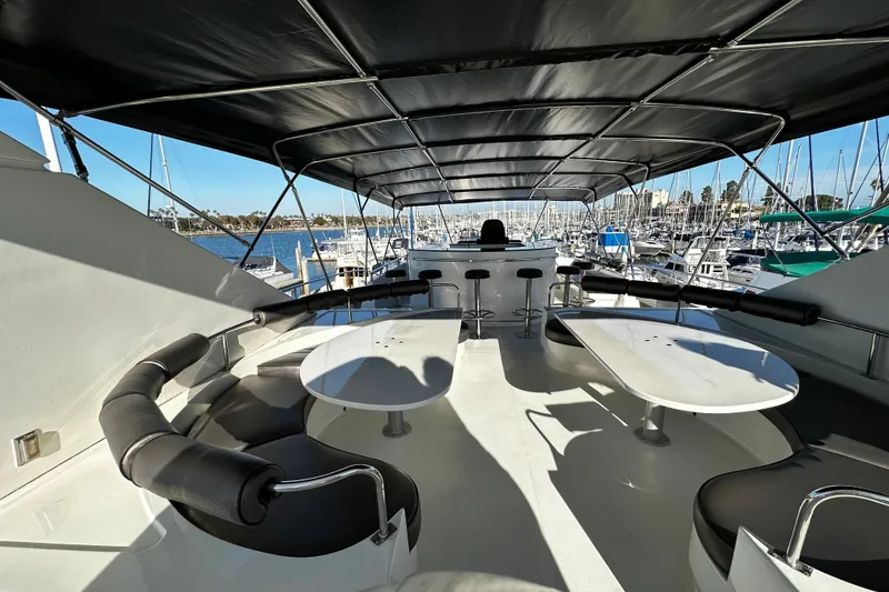Slide: The Image of Luxurious 1996 Monte Fino 92 yacht deck with seating and marina view. - 55