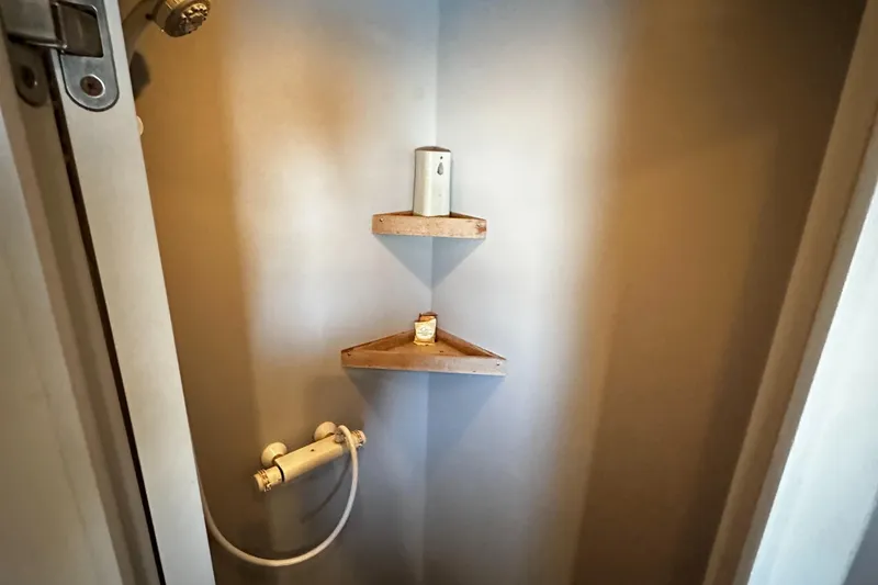 Slide: The Image of Shower area in 1996 Monte Fino 92 yacht with corner shelves and showerhead. - 58
