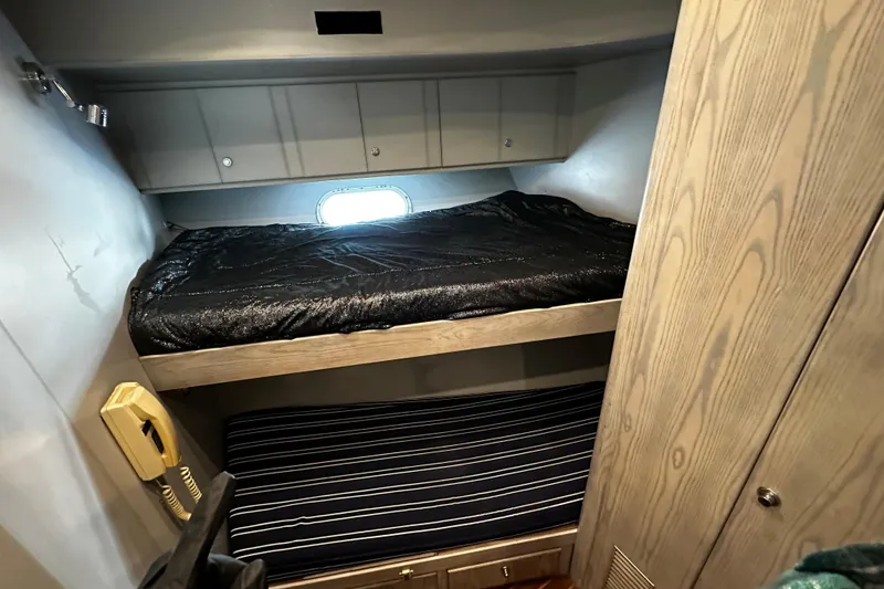 Slide: The Image of Interior cabin of 1996 Monte Fino 92 yacht with bunk beds and wooden cabinetry. - 60