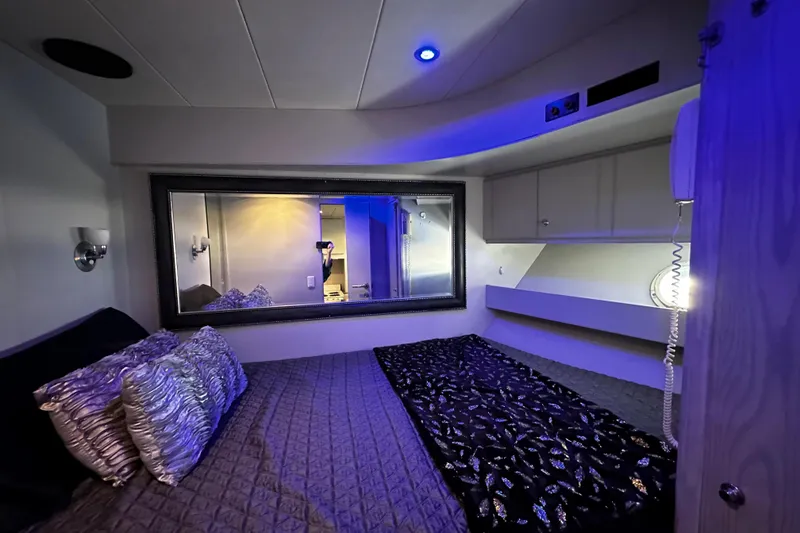 Slide: The Image of Luxurious bedroom interior of 1996 Monte Fino 92 yacht with elegant lighting and decor. - 62