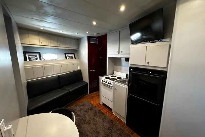 Slide: The Image of Interior of 1996 Monte Fino 92 yacht with kitchen, seating, and TV. - 63