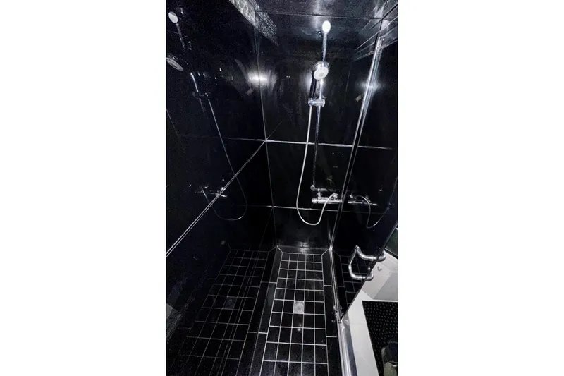 Slide: The Image of Luxurious black-tiled shower in 1996 Monte Fino 92 yacht, featuring modern fixtures. - 65