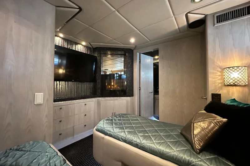 Slide: The Image of Luxurious Monte Fino 92 yacht interior with modern decor and cozy bedding, 1996 model. - 67