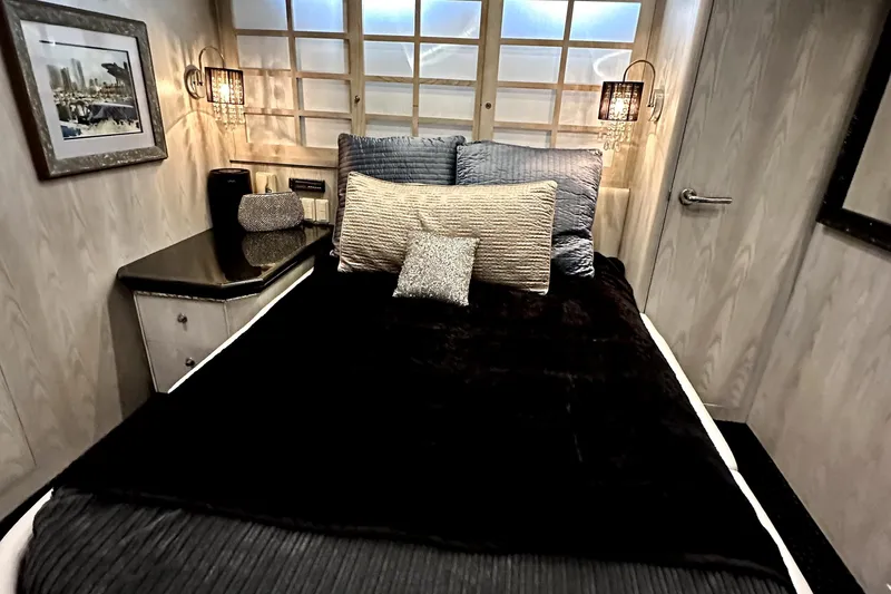 Slide: The Image of Luxurious bedroom interior on a 1996 Monte Fino 92 yacht, featuring elegant decor and plush bedding. - 71