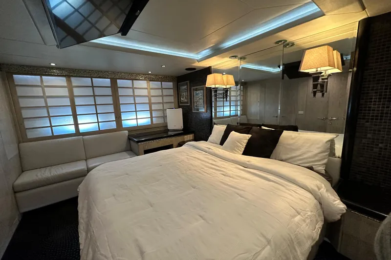 Slide: The Image of Luxurious bedroom interior on a 1996 Monte Fino 92 yacht, featuring elegant lighting and decor. - 72
