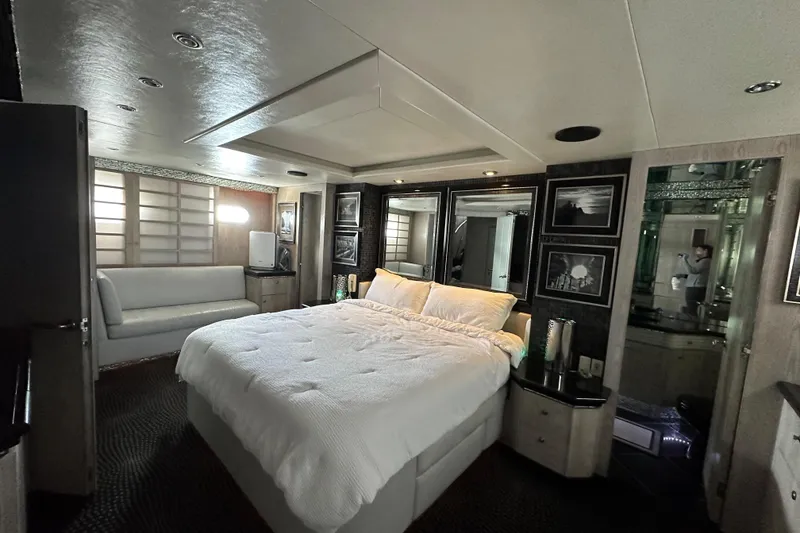 Slide: The Image of Luxurious bedroom interior on a 1996 Monte Fino 92 yacht, featuring elegant decor and comfortable bedding. - 76