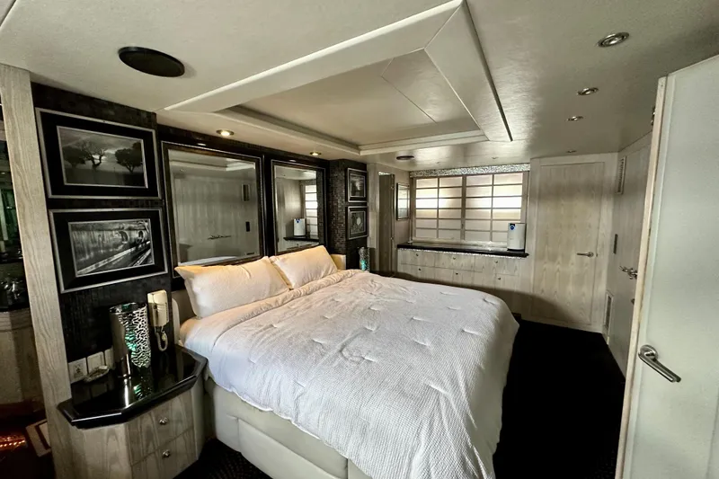 Slide: The Image of Luxurious bedroom interior on a 1996 Monte Fino 92 yacht, featuring elegant decor and comfortable bedding. - 77
