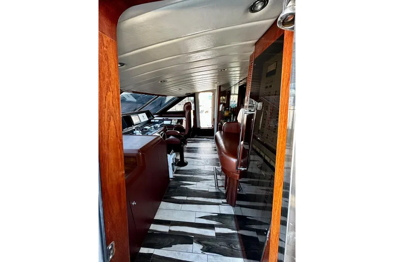 Slide: The Image of Interior view of 1996 Monte Fino 92 yacht cockpit with leather seating and control panels. - 78
