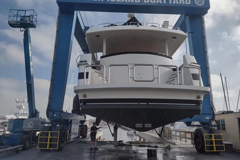 Slide: The Image of Monte Fino 92 yacht from 1996 in a boatyard lift, ready for maintenance. - 8