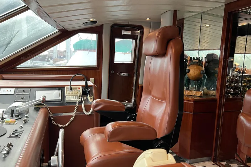 Slide: The Image of Luxurious Monte Fino 92 yacht interior with leather captain's chair and control panel, 1996 model. - 81