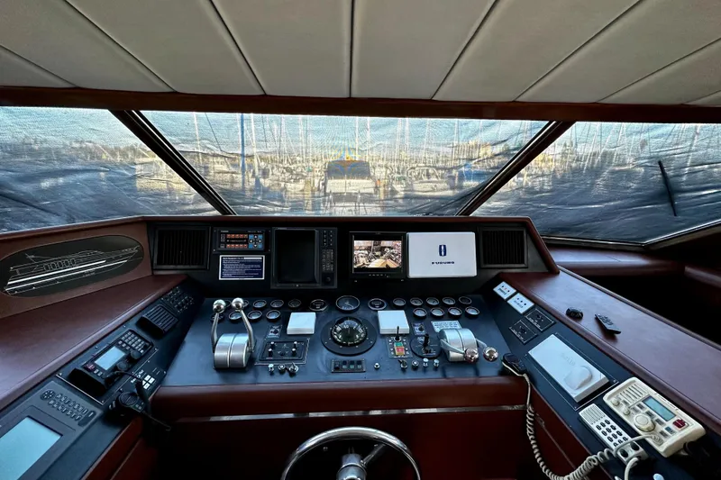 Slide: The Image of Cockpit of a 1996 Monte Fino 92 yacht with navigation controls and displays. - 83