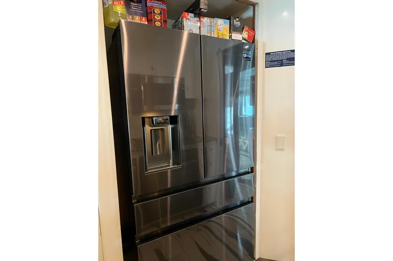 Slide: The Image of Stainless steel refrigerator with double doors and bottom freezer in a modern kitchen. - 84