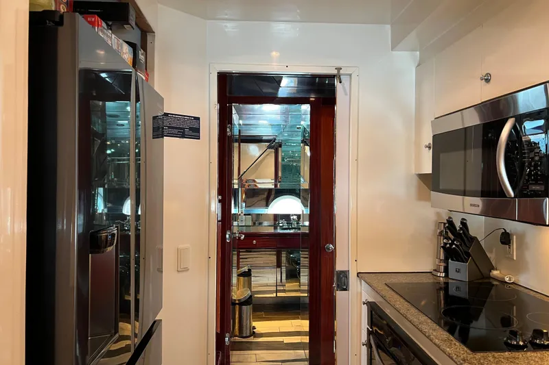 Slide: The Image of Kitchen interior of a 1996 Monte Fino 92 yacht with modern appliances. - 85