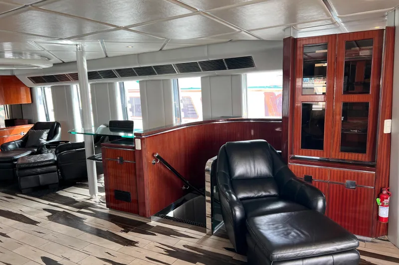 Slide: The Image of Luxurious interior of 1996 Monte Fino 92 yacht with leather seating and wooden cabinetry. - 89
