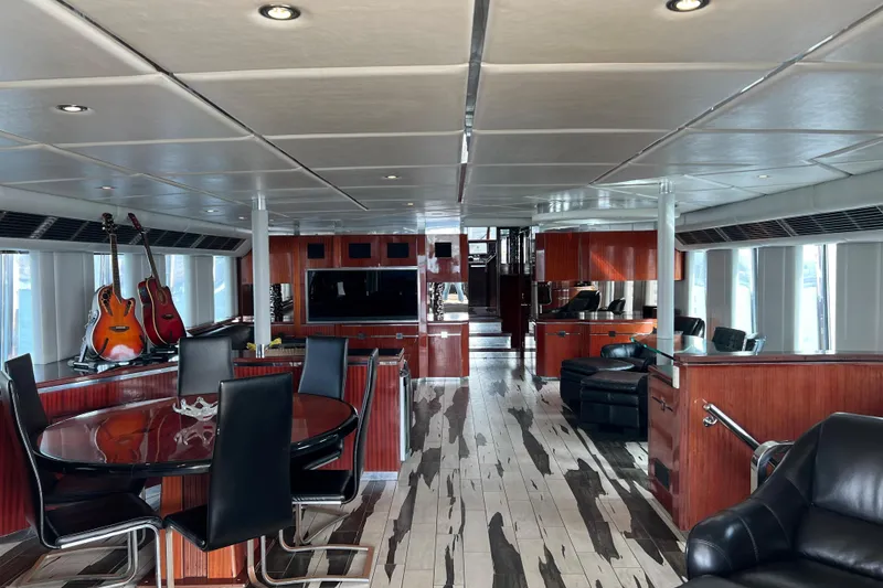 Slide: The Image of Luxurious interior of a 1996 Monte Fino 92 yacht with elegant wood finishes and modern furnishings. - 91