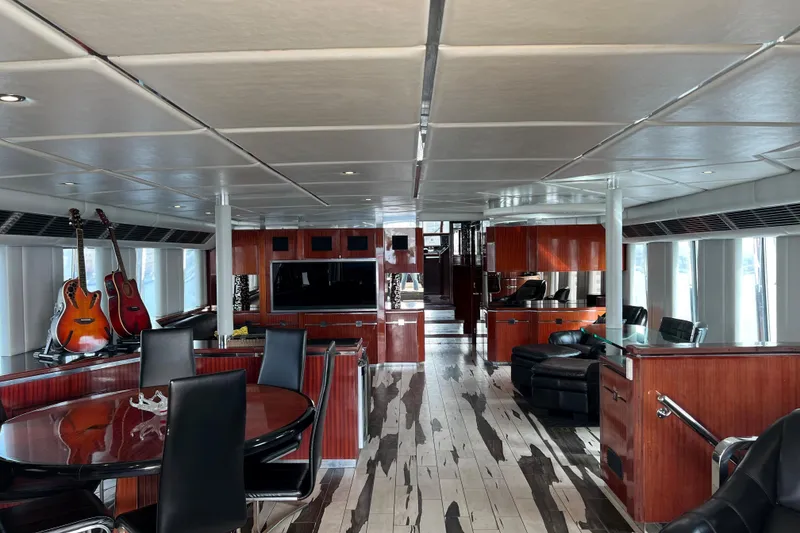Slide: The Image of Luxurious interior of a 1996 Monte Fino 92 yacht with elegant wood finishes and guitars. - 94