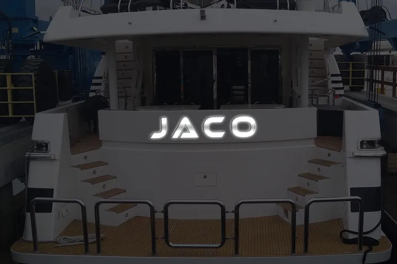 Slide: The Image of Stern view of 1996 Monte Fino 92 yacht with "JACO" signage. - 95