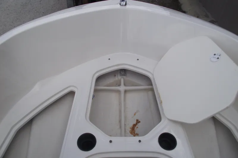 Slide: The Image of 2021 Bayliner Element E18 boat interior with storage compartment and cup holders. - 10
