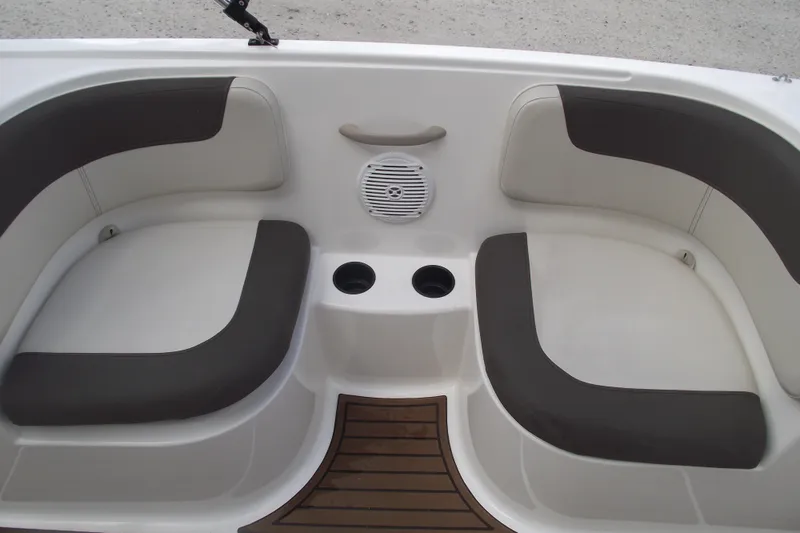 Slide: The Image of 2021 Bayliner Element E18 boat interior with cushioned seating and cup holders. - 15