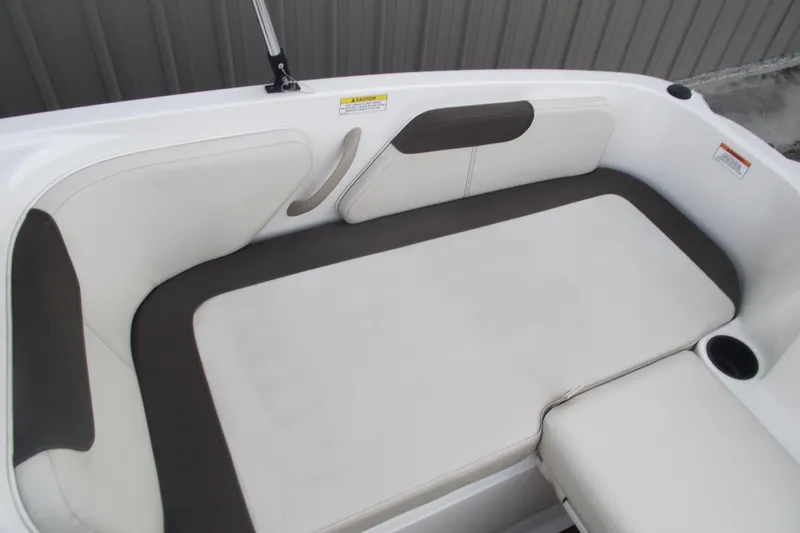 Slide: The Image of 2021 Bayliner Element E18 boat interior seating with white and gray upholstery. - 20
