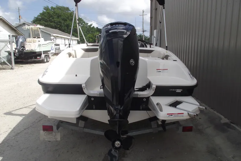 Slide: The Image of 2021 Bayliner Element E18 boat with outboard motor, parked outdoors. - 3