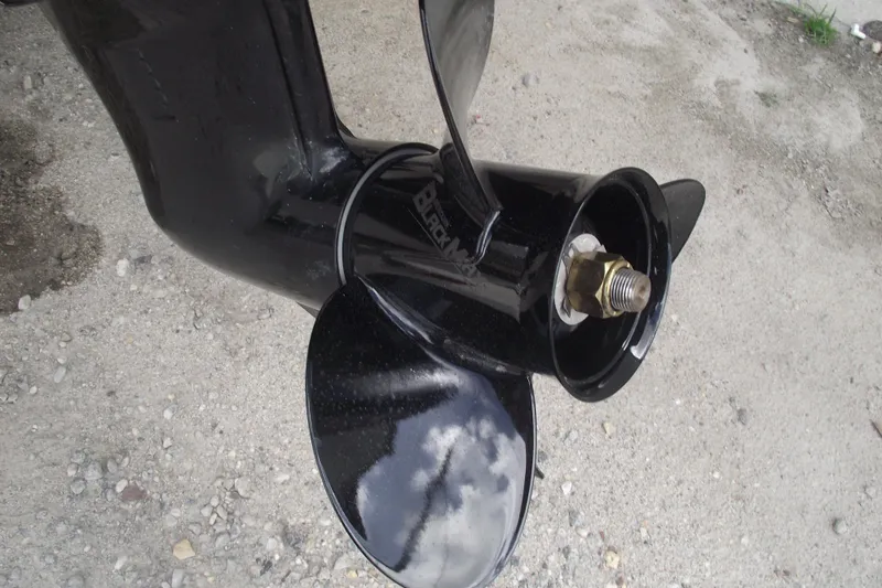 Slide: The Image of Close-up of a 2021 Bayliner Element E18 boat propeller on gravel surface. - 5