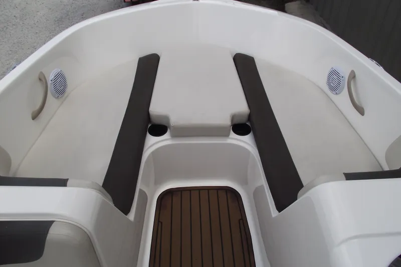 Slide: The Image of 2021 Bayliner Element E18 boat interior with cushioned seating and cup holders. - 6