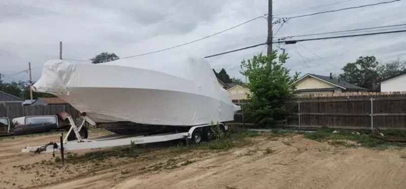 Slide: The Image of 2005 Four Winns 288 Vista boat covered on trailer outdoors. - 11