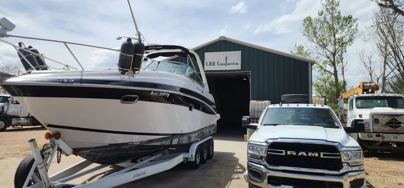 Slide: The Image of 2005 Four Winns 288 Vista boat on trailer in front of warehouse. - 2