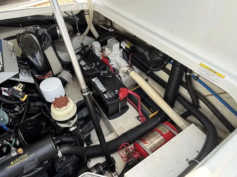 Slide: The Image of Engine compartment of 2010 Formula 270 Bowrider boat with batteries and fire extinguisher. - 16