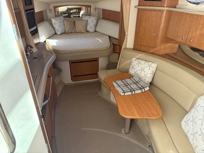 Slide: The Image of Interior of a 2006 Sea Ray Sundancer 320 yacht with cozy bed and seating area. - 10