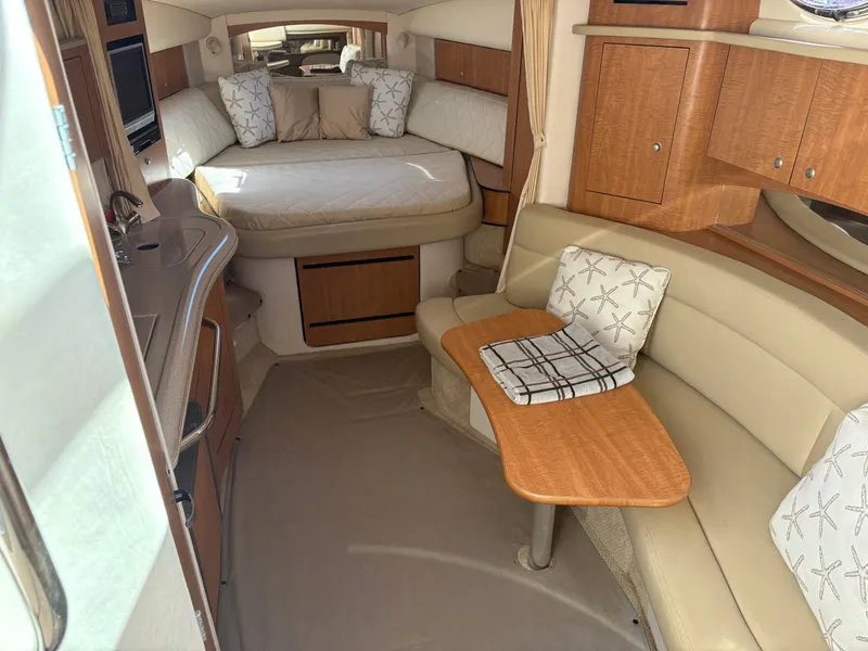 Slide: The Image of Interior of a 2006 Sea Ray Sundancer 320 with cozy bed and seating area. - 10