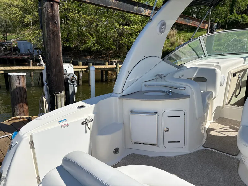 Slide: The Image of The image shows the cockpit of a 2006 Sea Ray Sundancer 320 with seating area and helm. - 7