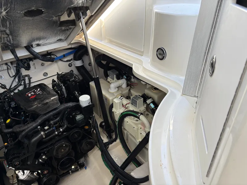 Slide: The Image of The engine compartment of a 2006 Sea Ray Sundancer 320 shows a well-maintained engine and wiring. - 21