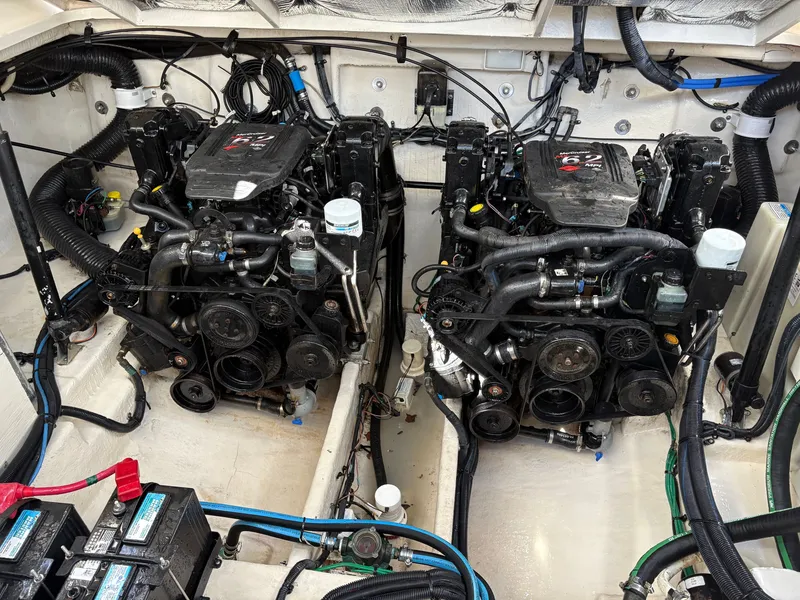 Slide: The Image of The engine room of a 2006 Sea Ray Sundancer 320 features two large engines and batteries. - 23